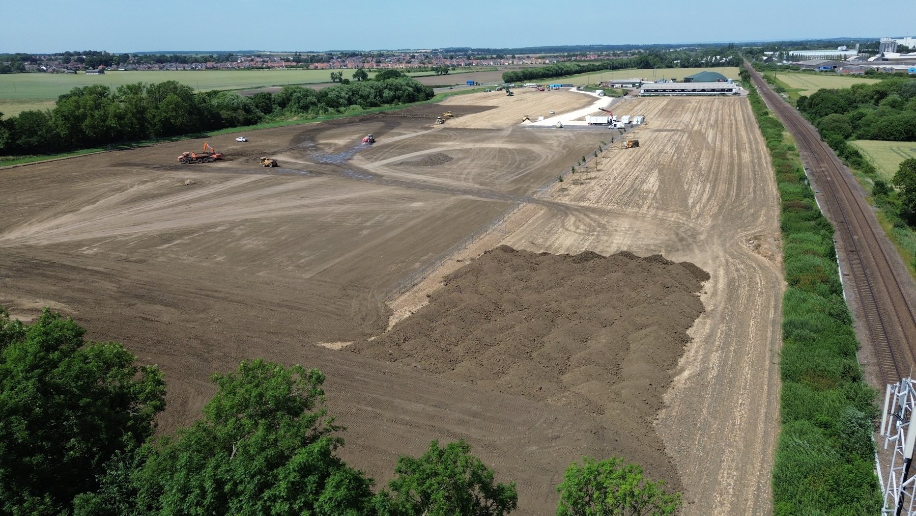 Wide aerial view of an active JJMac earthworks site