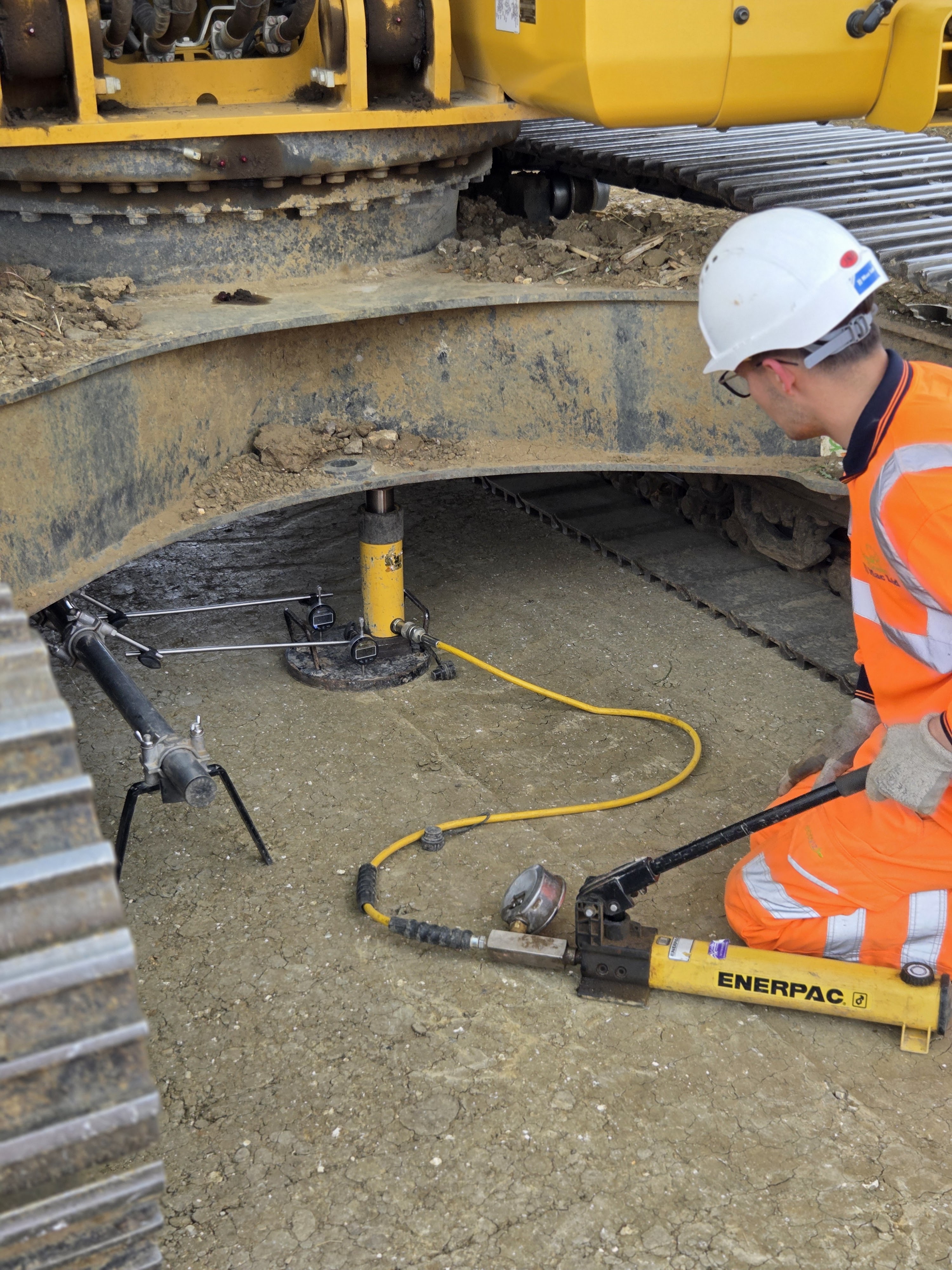 JJMac technician completing plate load testing beneath construction plant